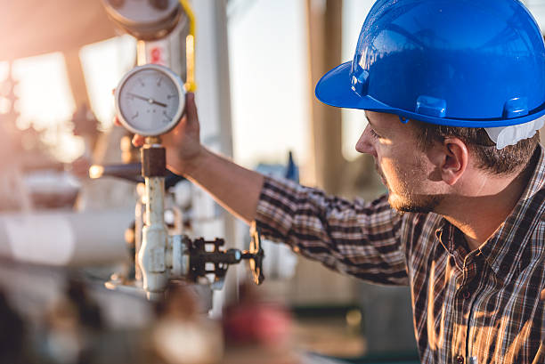 Man checking manometer in natural gas factory